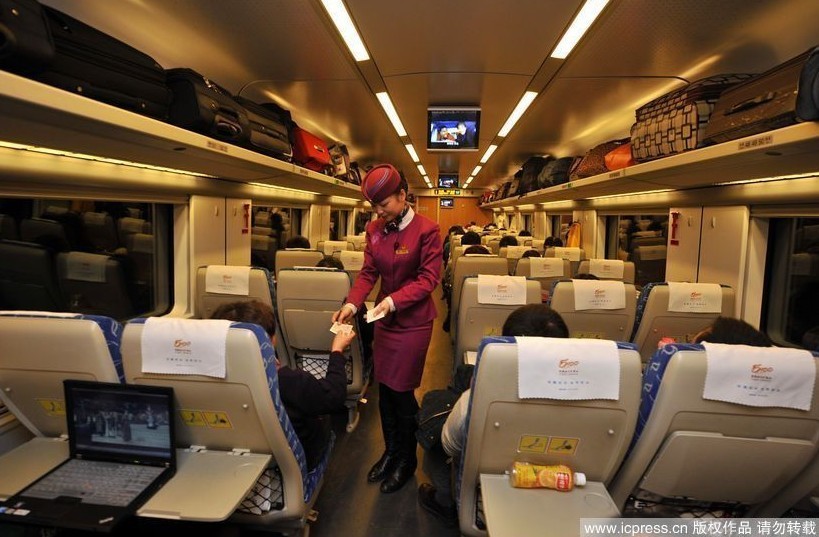 乘务员为二等软座旅客服务。图片署名:重庆晚