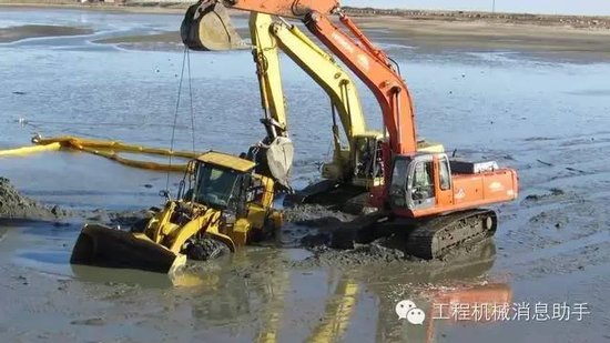 挖掘机海滩救被陷铲车半天无果