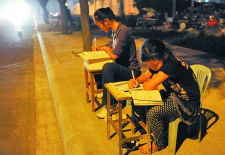 贫困姐妹路灯下学习 废品中挑书读想当作家