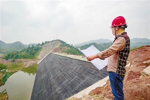 5月2日,重庆市观景口水利枢纽工程施工现场,工程师谭家儒正在检查施工