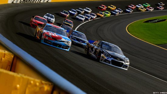 Cars drive round bend in a NASCAR race