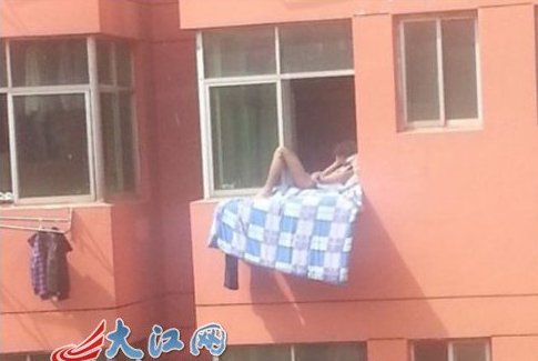 大学生赤裸躺在窗口晒太阳 被称 销魂哥 (图)