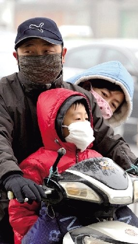 郑州近期雾霾绕城 市民帮雕塑“戴口罩”防霾