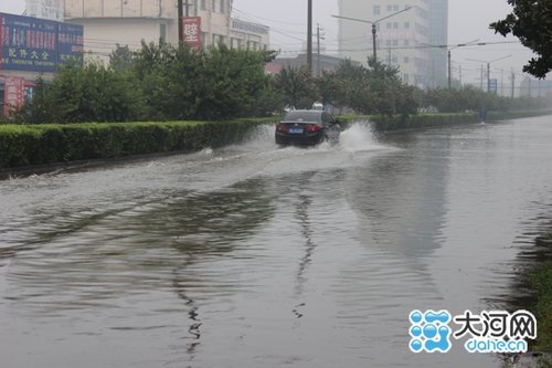 24日上10时许,汽车在漯河市桂江路一积水中穿梭行