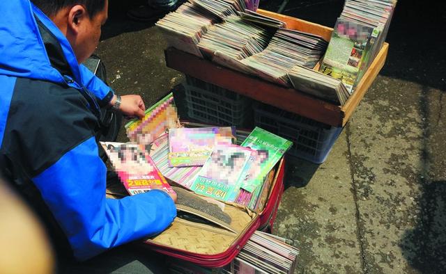 小贩向学生推销黄碟