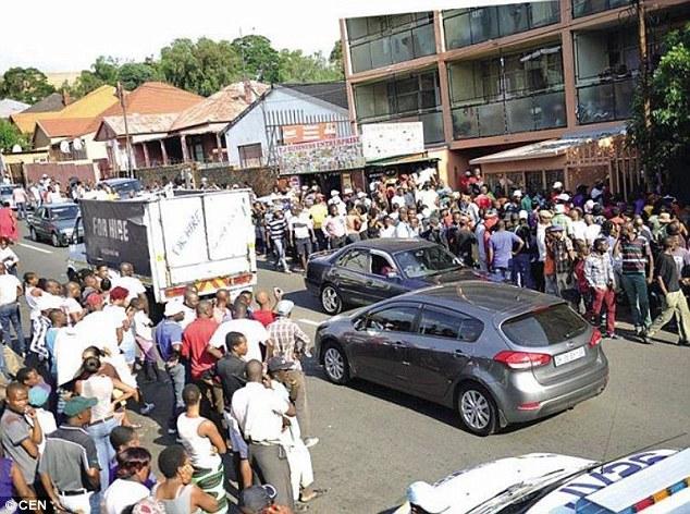 Police had to be called in to restore order after a crowd gathered to see a cheating wife and her lover locked together during sex after the rumour spread that her husband had asked a witch doctor to put a curse on her private parts