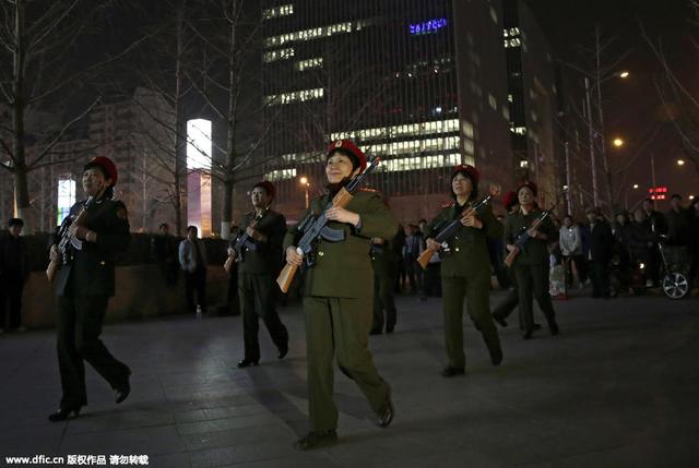 北京广场舞大妈穿军装持玩具枪在商场门口起舞