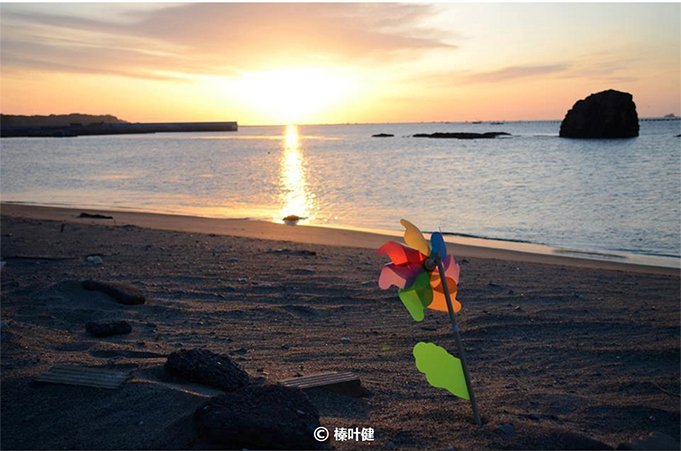 “3·11”地震两年后灾区海边的日出。在日本东北地区,人们会为早夭的婴儿准备风车,作为他们在另一个世界的玩具。 “3·11”地震两年后灾区海边的日出。在日本东北地区,人们会为早夭的婴儿准备风车,作为他们在另一个世界的玩具。