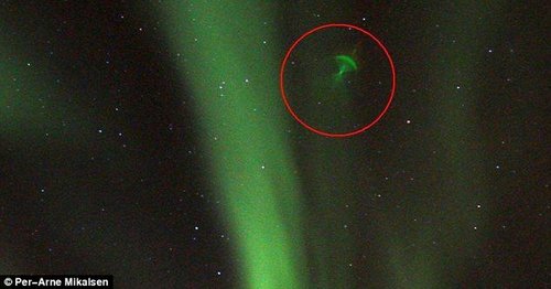 挪威夜空现“绿色水母” 卫星反射北极光所致