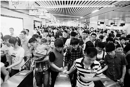5月1日,杭州地铁1号线龙翔桥站旅客排队出站,人流拥挤.