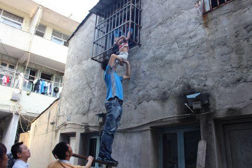 温州一小男孩卡在了二楼防盗窗上 看着好揪心